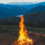 Bonfire Near Grass Field during Dawn