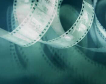 retro film, 35mm film, perforated, negative on pink background, with shadow, photo film, vintage film, film photography, analog film, vintage photography, retro photo