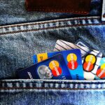 Close-up of a denim pocket with multiple credit cards, illustrating finance and fashion.