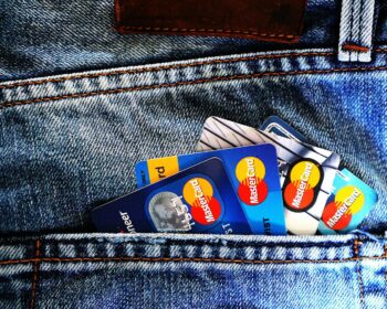 Close-up of a denim pocket with multiple credit cards, illustrating finance and fashion.