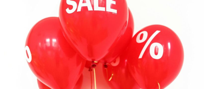 Bright red balloons with 'SALE' and '%' symbols, perfect for marketing promotions.