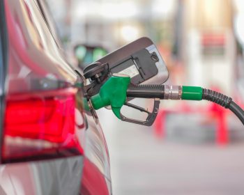 a gas pump is connected to a car at a gas station
