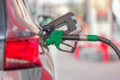 a gas pump is connected to a car at a gas station