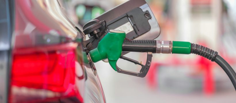 a gas pump is connected to a car at a gas station